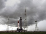 Storm clouds roll in over the NASA moon rocket as it stands ready for launch on Pad 39B for the Artemis 1 mission at the Kennedy Space Center in Cape Canaveral, Florida. The launch is scheduled for Monday morning August 29. (AP Photo/John Raoux) Storm clouds roll in over the NASA moon rocket as it stands ready for launch on Pad 39B for the Artemis 1 mission at the Kennedy Space Center in Cape Canaveral, Florida. The launch is scheduled for Monday morning August 29. (AP Photo/John Raoux)