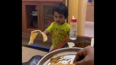 A screengrab from the viral video shows a toddler named Joshiik serving dosa with a perfect flip to his parent. (Instagram/@josh_iik) A screengrab from the viral video shows a toddler named Joshiik serving dosa with a perfect flip to his parent. (Instagram/@josh_iik)