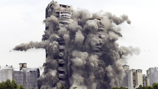 A controlled implosion demolishes the 100-metre-high residential in Noida on Sunday. (Arvind Yadav/HT PHOTO)