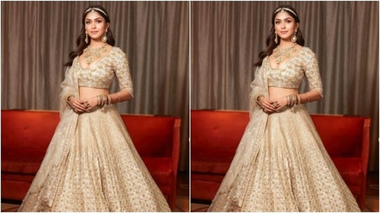 Mrunal decked up in white and golden embroidered blouse with a sweetheart neckline and teamed it with a long flowy white and golden skirt that came heavily embroidered in resham threads and zari work.(Instagram/@mrunalthakur)