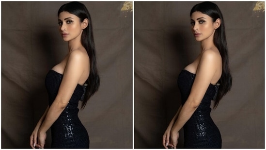 Mouni glammed up her must-have party look by leaving her long mane open in a centre parting, and for the glam picks, she chose black winged eyeliner, matte nude lip shade, shimmering eye shadow, dewy base, mascara on the lashes, bronzer and blush on the cheeks, and sharp contouring.(Instagram/@imouniroy)
