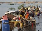 Families sit near their belongings surrounded by floodwaters, in Sohbat Pur city of Jaffarabad, a district of Pakistan's southwestern Baluchistan province, Sunday. Families sit near their belongings surrounded by floodwaters, in Sohbat Pur city of Jaffarabad, a district of Pakistan's southwestern Baluchistan province, Sunday. 