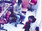 CCTV footage shows one of the robbers with hostages.