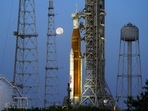 The moon sets in front of the NASA Artemis rocket with the Orion spacecraft aboard on pad 39B at the Kennedy Space Center.(AP)