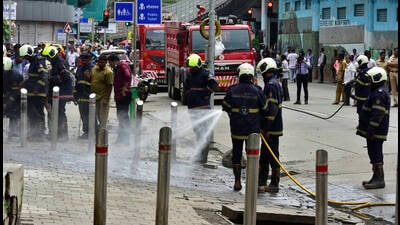 Fire Brigade personnel trying to douse a fire in underground utility electricity cable at Parel on Monday (Anshuman Poyrekar/HT PHOTO) Fire Brigade personnel trying to douse a fire in underground utility electricity cable at Parel on Monday (Anshuman Poyrekar/HT PHOTO)