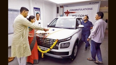 A family purchases a petrol car at a Hyundai showroom on Shankarshet road. (Rahul Raut/HT PHOTO)