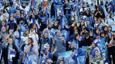 Iranian women fans of Esteghlal football club cheer during a match between Esteghlal and Mes Kerman at the Azadi stadium in the capital Tehran. (AFP) Iranian women fans of Esteghlal football club cheer during a match between Esteghlal and Mes Kerman at the Azadi stadium in the capital Tehran. (AFP)