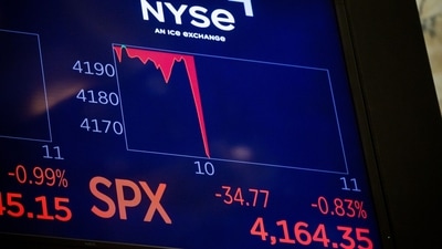 Stock markets initial reaction on a monitor as Jerome Powell, chairman of the US Federal Reserve, speaks at the Jackson Hole Economic Policy Symposium on the floor of the New York Stock Exchange (NYSE) in New York, US, on Friday. (Bloomberg)