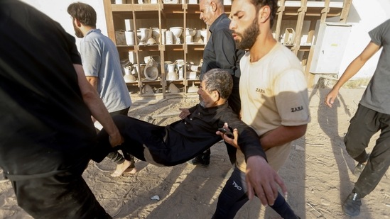 People carry a man amidst a protest of suporters of Iraqi populist leader Muqtada al-Sadr at the Green Zone, in Baghdad, Iraq August 29, 2022.&nbsp;(REUTERS)