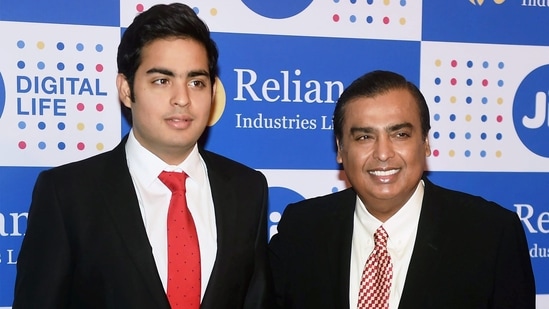 Mukesh Ambani, chairman, Reliance Industries Ltd, with his son Akash Ambani at the company's annual general meeting in Mumbai.(PTI file)