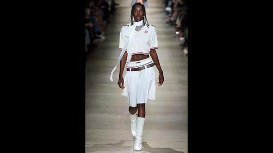 A model walks the ramp wearing tennis top and skirt at Miu Miu’s Fall 2022 ready-to-wear collection