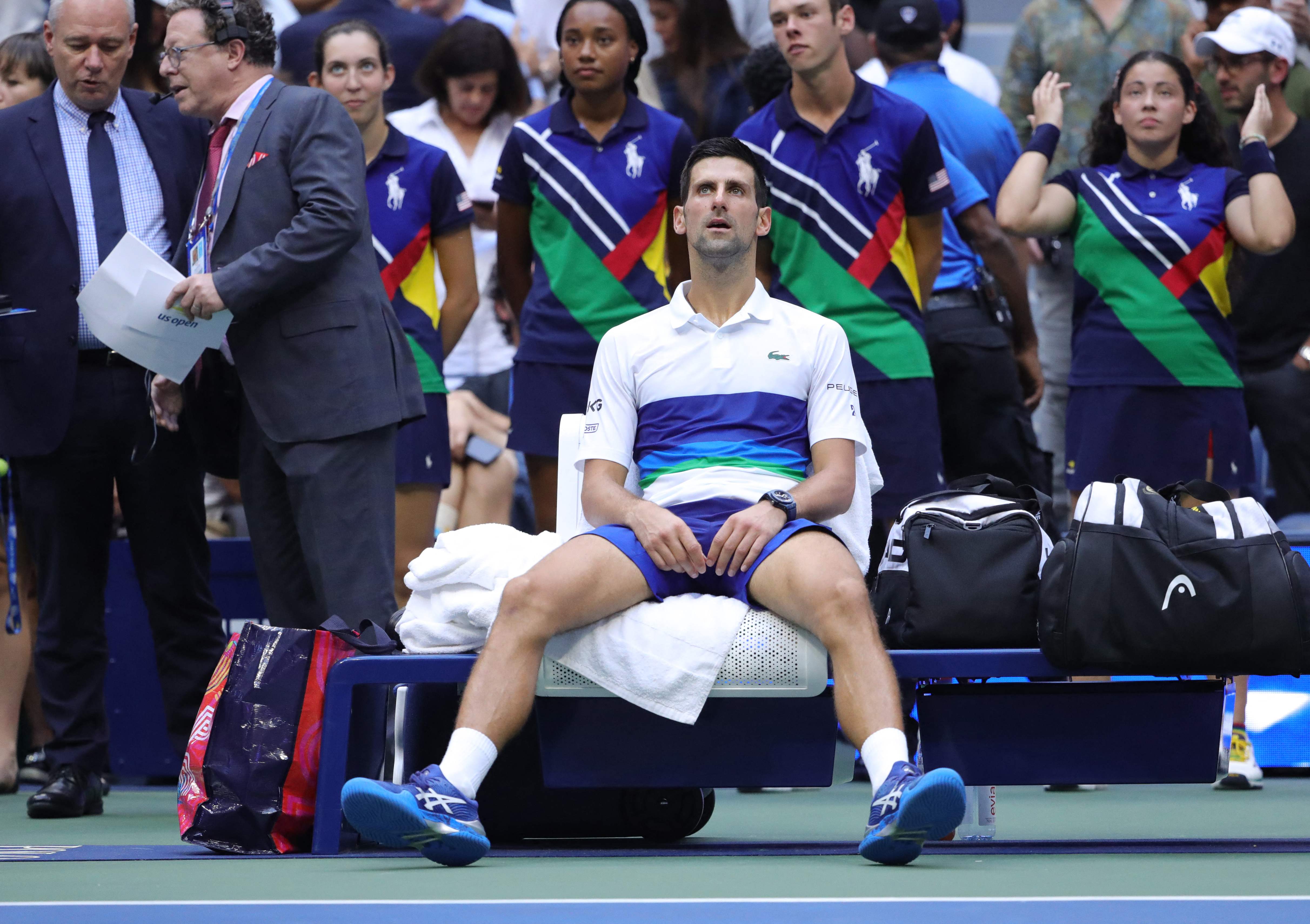 Serbia's Novak Djokovic sits in his courtside chair&nbsp;