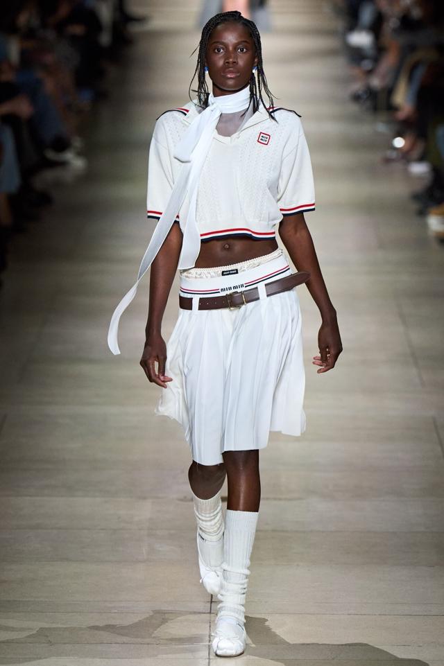 A model walks the ramp wearing tennis top and skirt at Miu Miu’s Fall 2022 ready-to-wear collection A model walks the ramp wearing tennis top and skirt at Miu Miu’s Fall 2022 ready-to-wear collection