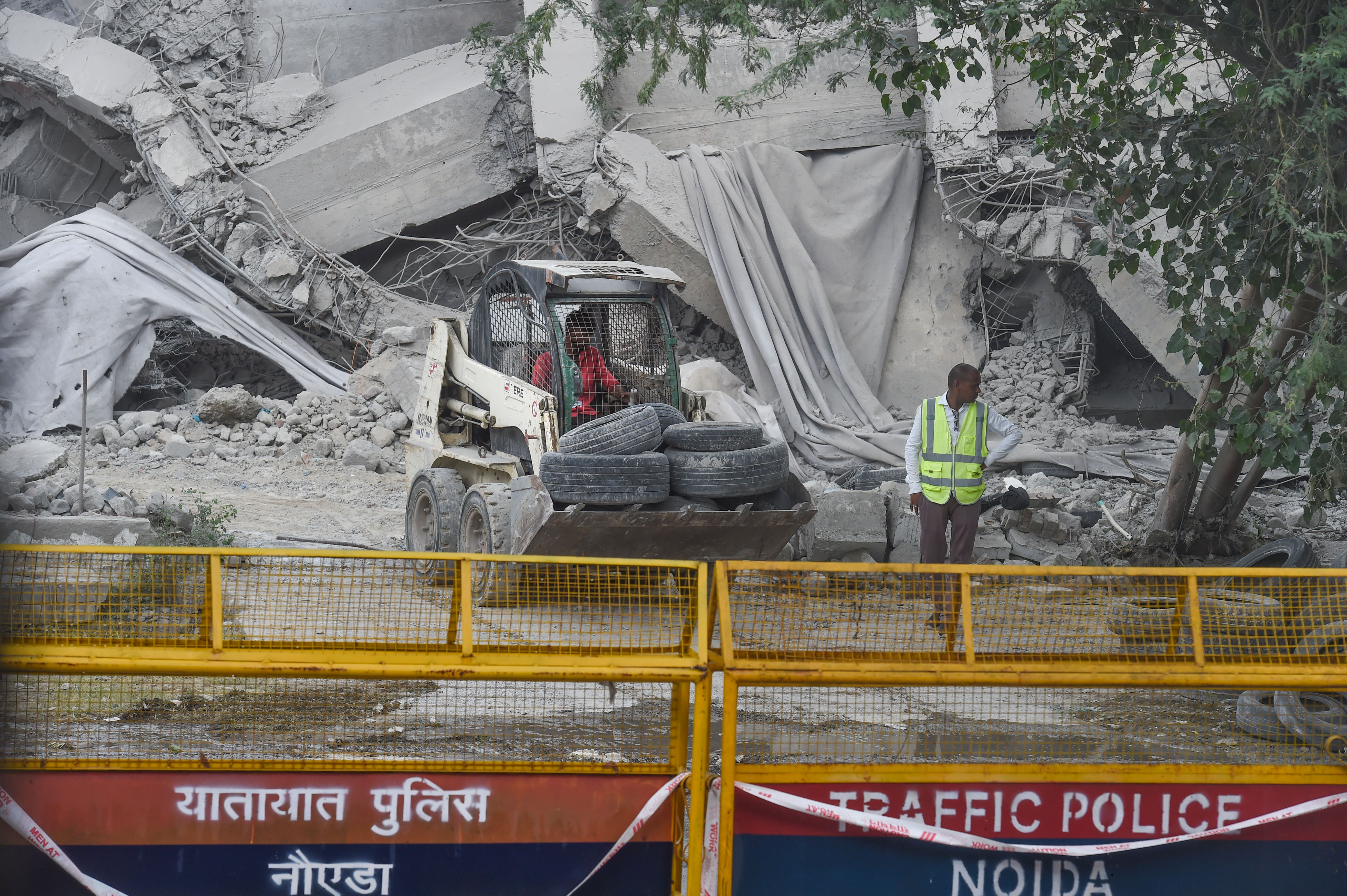 Workers near debris of the demolished twin towers of Supertech, in Noida on Monday, August 29, 2022. (PTI Photo/Atul Yadav) Workers near debris of the demolished twin towers of Supertech, in Noida on Monday, August 29, 2022. (PTI Photo/Atul Yadav)