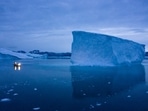 A boat navigates at night next to large icebergs in eastern Greenland in August 2019.(AP) A boat navigates at night next to large icebergs in eastern Greenland in August 2019.(AP)
