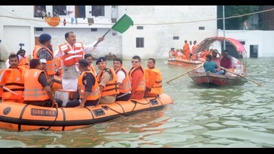 Deputy CM Keshav Prasad Maurya on a boat distributing relief to flood-affected people in Prayagraj on Tuesday. (HT) Deputy CM Keshav Prasad Maurya on a boat distributing relief to flood-affected people in Prayagraj on Tuesday. (HT)