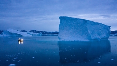 A boat navigates at night next to large icebergs in eastern Greenland in August 2019. (AP) A boat navigates at night next to large icebergs in eastern Greenland in August 2019. (AP)