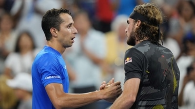 Daniel Elahi Galan of Colombia, left, and Stefanos Tsitsipas of Greece shake hands after their first round match on day one of the 2022 U.S. Open tennis tournament at USTA Billie Jean King National Tennis Center. (USA TODAY Sports)