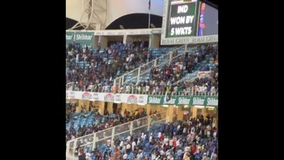 The image, taken from the viral video on Twitter, shows a crowd-packed stadium and a scoreboard flashing ‘IND WON BY 5 WKTS’. (Twitter/@dhruv_rathee)