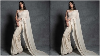 On Tuesday, Mouni took to Instagram to drop pictures from a new photoshoot with a white heart as a caption. The Brahmastra actor's traditional look is from the shelves of designer Sawan Gandhi's clothing label. It features an ivory saree and a stylish blouse to complement the six yards. (Instagram) On Tuesday, Mouni took to Instagram to drop pictures from a new photoshoot with a white heart as a caption. The Brahmastra actor's traditional look is from the shelves of designer Sawan Gandhi's clothing label. It features an ivory saree and a stylish blouse to complement the six yards. (Instagram)