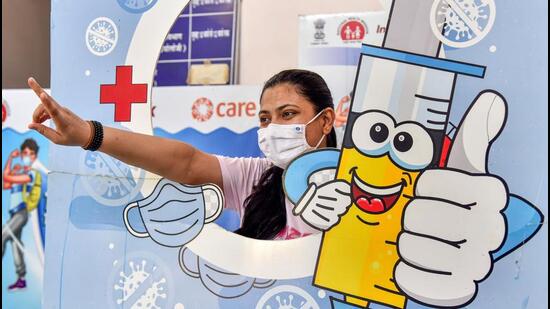 A woman poses for pictures at a vaccination centre after taking the Covid-19 booster shot in Rajasthan. (PTI Photo)