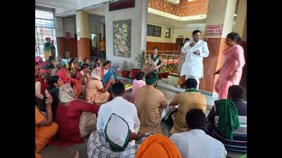 Women from SHGs and BKU leaders staging dharna at the office of the project director. (HT Photo)
