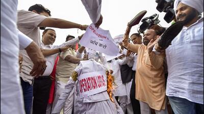 AAP MLAs protest outside Delhi assembly on Wednesday demanding a probe into the alleged 'Operation Lotus' of BJP. (PTI Photo) AAP MLAs protest outside Delhi assembly on Wednesday demanding a probe into the alleged 'Operation Lotus' of BJP. (PTI Photo)