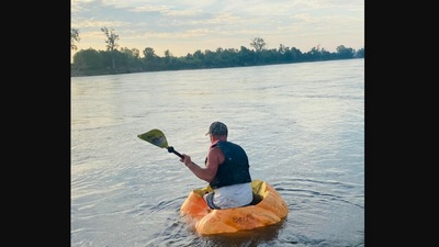 The image, taken from the Facebook post, shows the man using a pumpkin as a boat to take a river trip. (Facebook/@City of Bellevue, Nebraska)