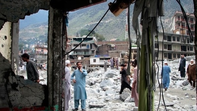 Pakistan flood fury:; People salvage usable items from a damaged hotel after flooding in the town of Bahrain, Pakistan,&nbsp; (AP)
