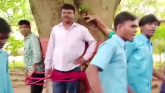 News agency ANI posted pictures of the incident showing teachers held by a tree with a red rope, surrounded by a group of agitated students in school uniform.