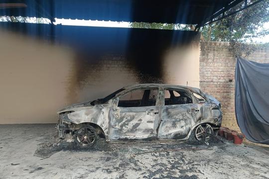 The car that the miscreants set ablaze before fleeing from the church early on Wednesday. (HT Photo) The car that the miscreants set ablaze before fleeing from the church early on Wednesday. (HT Photo)