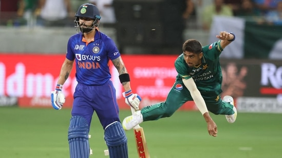 Shahnawaz Dahani delivers a ball as Virat Kohli watches from the non-striker's end during Asia Cup encounter in Dubai(AFP)