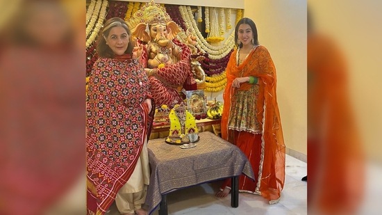 Sara Ali Khan celebrated Ganesh Chturthi at home with her mother Amrita Singh. The mother daughter duo, dressed in traditional attire, posed near Lord Ganesha's idol with smiles in their faces.(Instagram/@saraalikhan95)