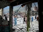 Pakistan flood fury:; People salvage usable items from a damaged hotel after flooding in the town of Bahrain, Pakistan,&nbsp;(AP)