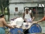 People push the makeshift boat in knee-deep water in Bihar's Bhagalpur district. (Screengrab/ANI video)