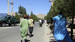 Afghan people run near the site of an explosion in Herat province, Afghanistan, Friday, Sept 2, 2022.&nbsp;