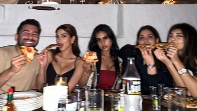 In another photo, Orhan Awatramani is sitting next to Boney Kapoor and Sridevi's daughter Khushi Kapoor and Nysa Devgan, with two of their other friends. All of them are holding pizza slices as they posed for a photo. In the pictures, while Nysa wore a red dress, Khushi went for an all-black outfit. 