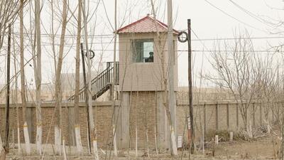 A security guard watches from a tower around a detention facility in Yarkent County in northwestern China’s Xinjiang Uighur Autonomous Region on March 21, 2021. (AP) A security guard watches from a tower around a detention facility in Yarkent County in northwestern China’s Xinjiang Uighur Autonomous Region on March 21, 2021. (AP)