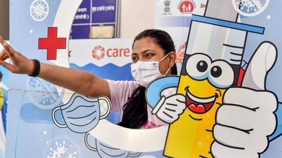 A woman poses for pictures at a vaccination centre after taking the Covid-19 booster shot in Rajasthan. (PTI Photo)