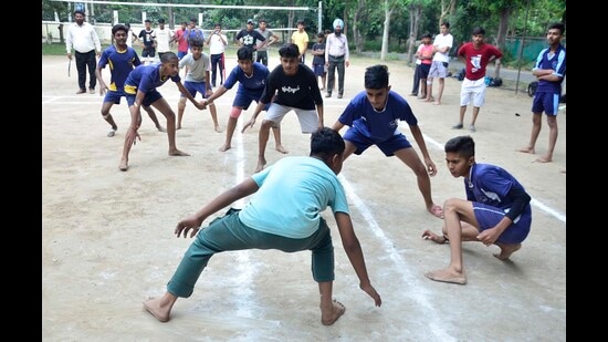 Players in action during the kabaddi match being played under Punjab Khed Mela at Guru Nanak Stadium in Ludhiana. (Harvinder Singh/HT)