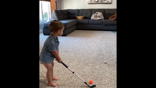 The image, taken from the viral Instagram video, shows a toddler playing golf.(Instagram/@thetoddlergolfer)