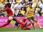 Sam Kerr, right, of Australia, is tackled by Sura Yekka, left, and Bianca St. Georges of Canada during the women's soccer friendly between Australia and Canada at Suncorp Stadium in Brisbane, Australia, Saturday, Sept. 3, 2022. Sam Kerr, right, of Australia, is tackled by Sura Yekka, left, and Bianca St. Georges of Canada during the women's soccer friendly between Australia and Canada at Suncorp Stadium in Brisbane, Australia, Saturday, Sept. 3, 2022. 