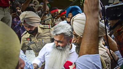 Congress leader Bharat Bhushan Ashu comes out after appearing before a court in an alleged food grain transportation tenders scam in Ludhiana. (PTI)