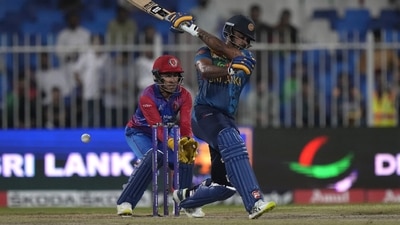 Sri Lanka's Danushka Gunathilaka, front, plays a shot while Afghanistan's wicketkeeper Rahmanullah Gurbaz watches during the T20 cricket match of Asia Cup between Sri Lanka and Afghanistan (AP) Sri Lanka's Danushka Gunathilaka, front, plays a shot while Afghanistan's wicketkeeper Rahmanullah Gurbaz watches during the T20 cricket match of Asia Cup between Sri Lanka and Afghanistan (AP)