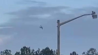 A small airplane circles over Tupelo, Miss., on Saturday. Police say the pilot of the small airplane is threatening to crash the aircraft into a Walmart store.&nbsp; (AP)