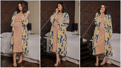 Neha Dhupia's maternity fashion is on point Her long, blue, pink, and yellow shrug, which fits her body wonderfully and gives it a sleek structure, makes her appear elegant. Her fashionable yet comfortable outfit choices are stylish and sophisticated. (Instagram/@nehadhupia)