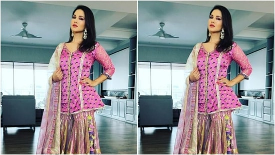 Sunny looked stunning in a pink gharara set. The actor decked up in a pink short kurta with full sleeves, golden zari details and prints in shades of black.(Instagram/@sunnyleone)