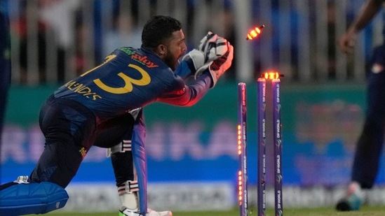 Sri Lanka's wicketkeeper Kusal Mendis, right, removes bails to run out Afghanistan's Rashid Khan during the T20 cricket match of Asia Cup between Sri Lanka and Afghanistan(AP)