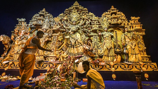 A Hindu priest performs rituals before the idol of Goddess Durga at a community pandal. (PTI Photo/Swapan Mahapatra)