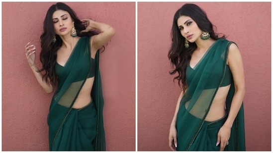 Mouni's see-through champagne green saree comes in a see-through silhouette and features shimmering sequinned patti embroidered on the borders. The actor draped the six yards around her svelte frame in traditional style, pleating the pallu on her shoulders and flaunting her toned midriff.(Instagram)